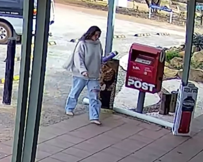 Backpacker in casual clothes walking near a post box in Australian outback area after unexplained behaviour incident. Backpacker in casual clothes walking near a post box in Australian outback area after unexplained behaviour incident.