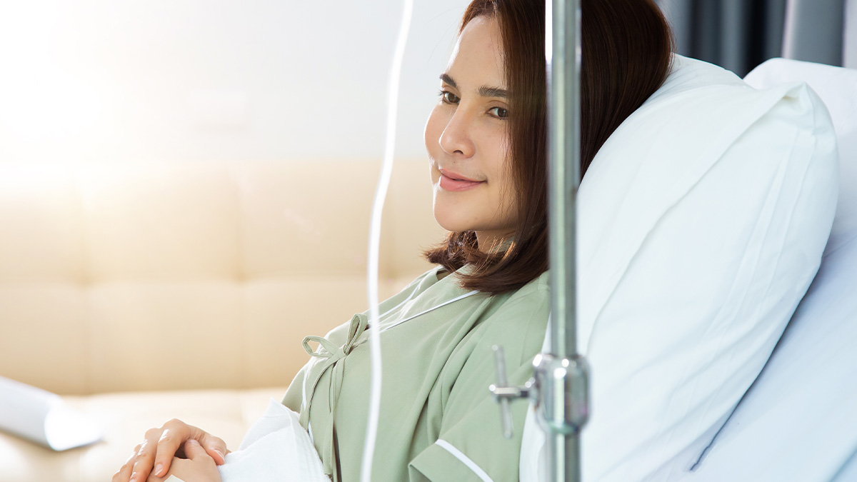 Woman recovering in hospital bed with IV drip, reflecting on her near-death experience and answering questions.