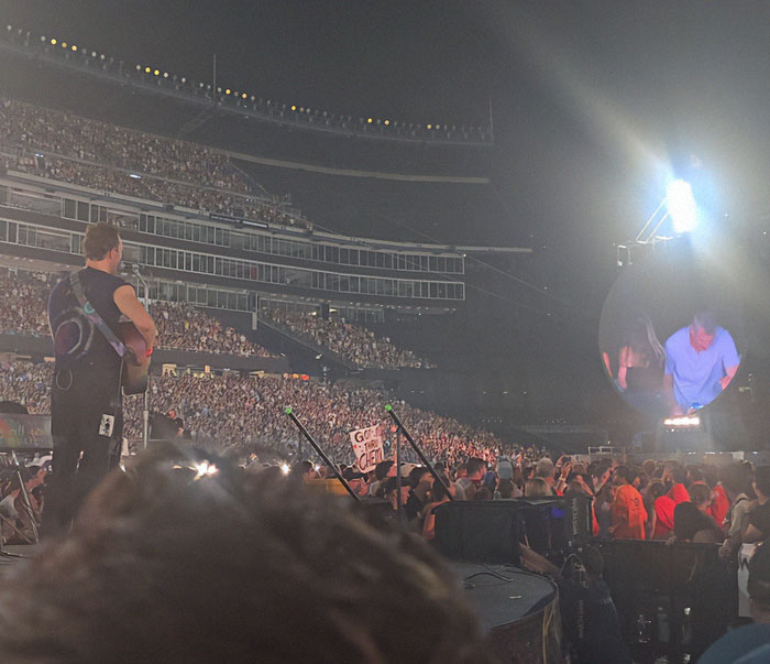 Coldplay concert with large crowd and stage view amid wife of CEO accused of cheating scandal discussion. Coldplay concert with large crowd and stage view amid wife of CEO accused of cheating scandal discussion.