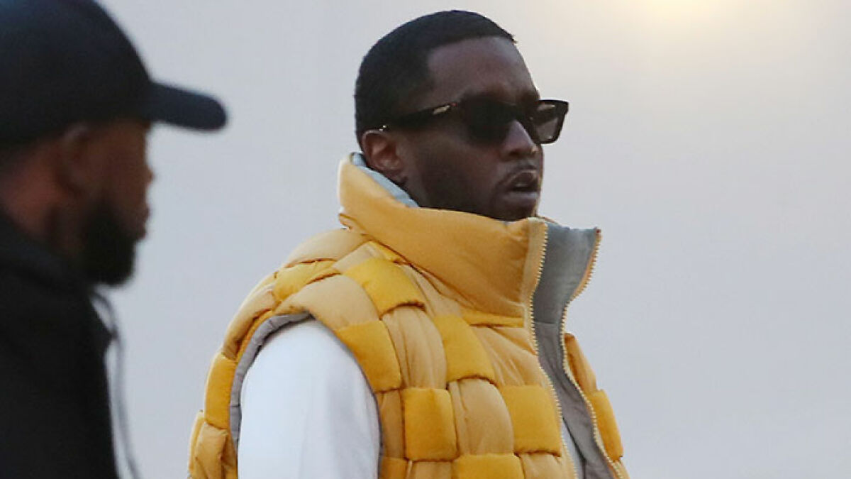 Diddy wearing sunglasses and a yellow puffer vest amid chaotic trial moments after jury surprise note.