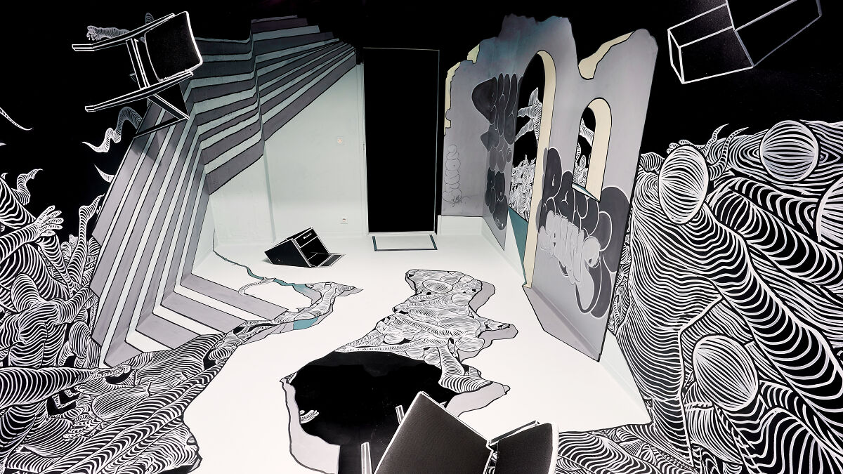 Anamorphic drawing installation with black and white patterns and distorted furniture at the Purkutaide exhibition in Helsinki.