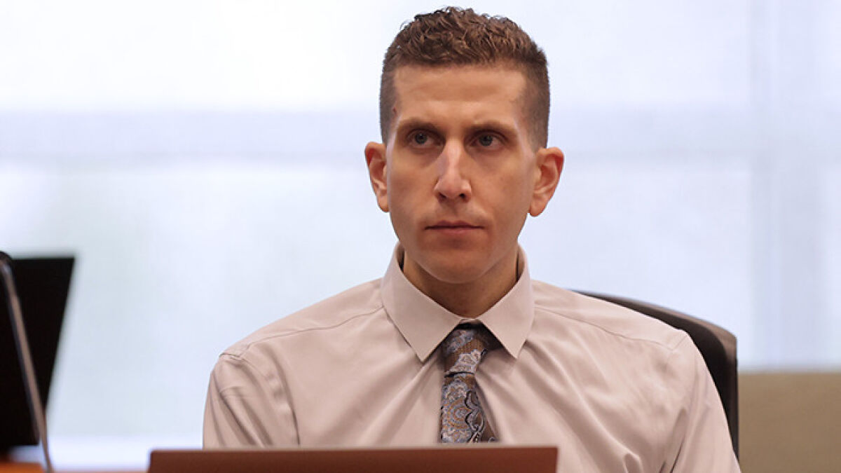Man in dress shirt and patterned tie sitting in a courtroom, related to mother of Bryan Kohberger's victim case.