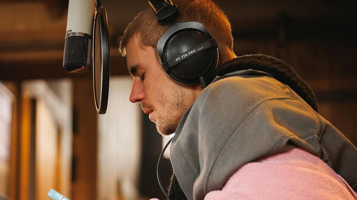 Justin Bieber wearing headphones in a studio, reflecting on marriage and mental struggles for new album SWAG.