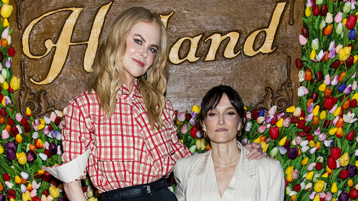 Two stars posing at an event, showcasing notable height difference highlighting super tall celebrities over 6 feet.