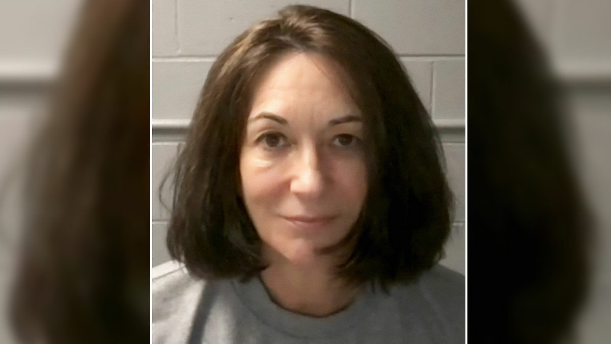 Ghislaine Maxwell looking at camera with neutral expression, family breaks silence after government closes Epstein case.