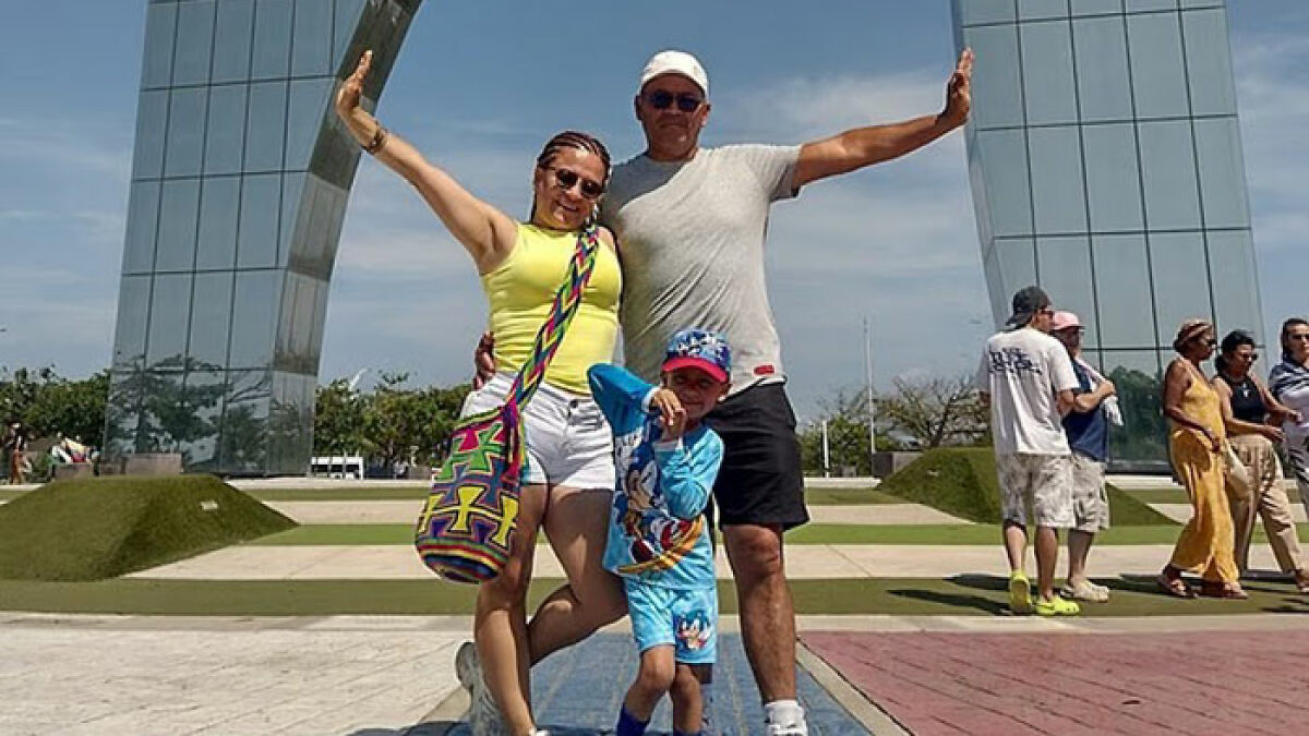 Family of 3 posing happily outdoors, highlighting the tragic case of family found lifeless in hotel room after strange smell complaints.
