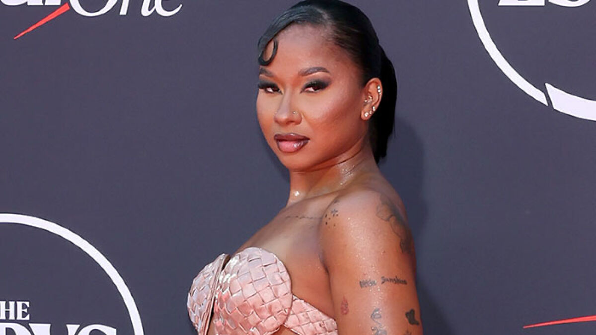 Sports star posing on red carpet wearing a pink woven strapless dress, showcasing worst dressed looks at 2025 ESPYs event.