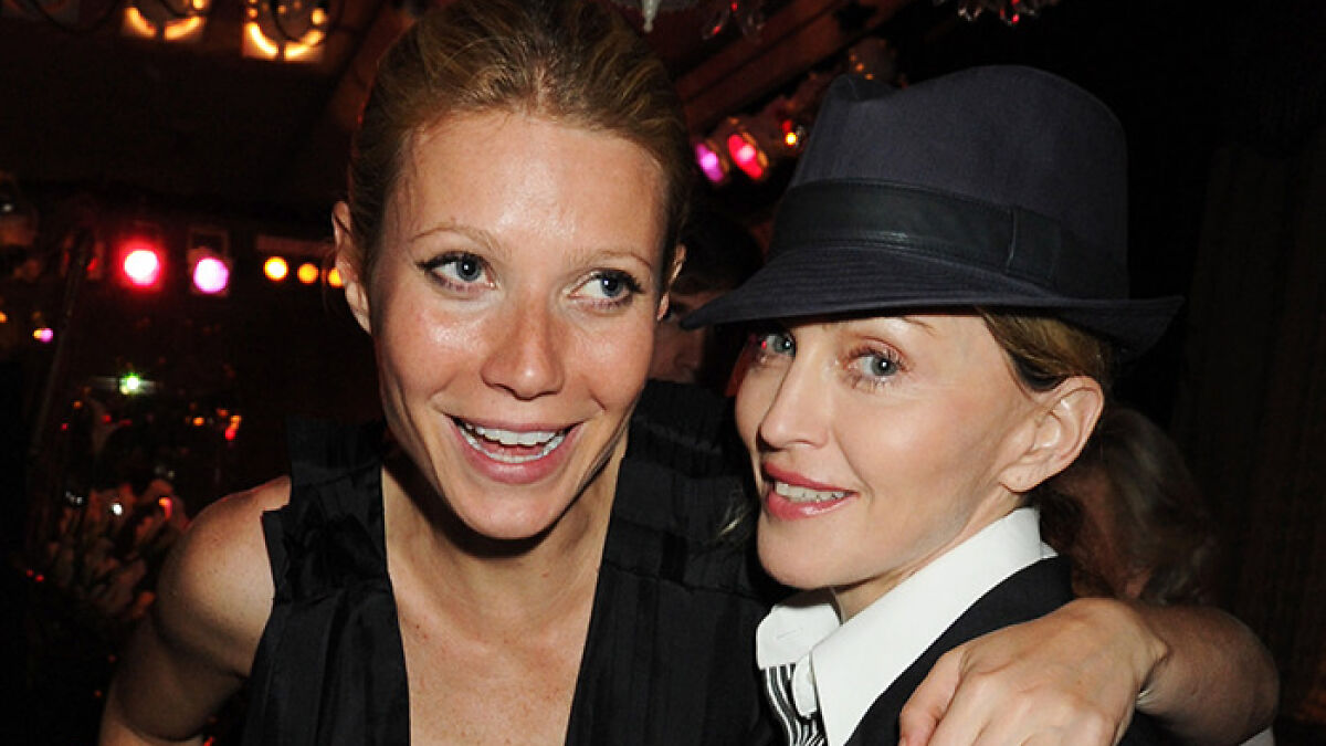 Gwyneth Paltrow and Madonna smiling together at an event before their friendship ended due to a vacation incident.