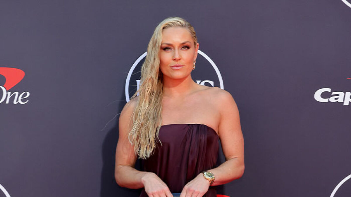 Lindsey Vonn on the ESPYs red carpet wearing a strapless dress with wet-look hair and gold watch.