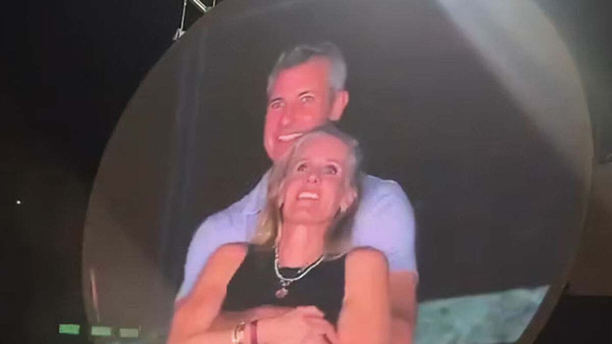 Man and woman embracing at night, related to CEO comments and HR chief in Coldplay scandal investigation.