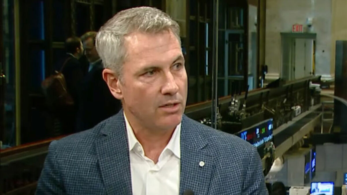 Astronomer founder speaking in an interview, wearing a blue checkered blazer and white shirt indoors.