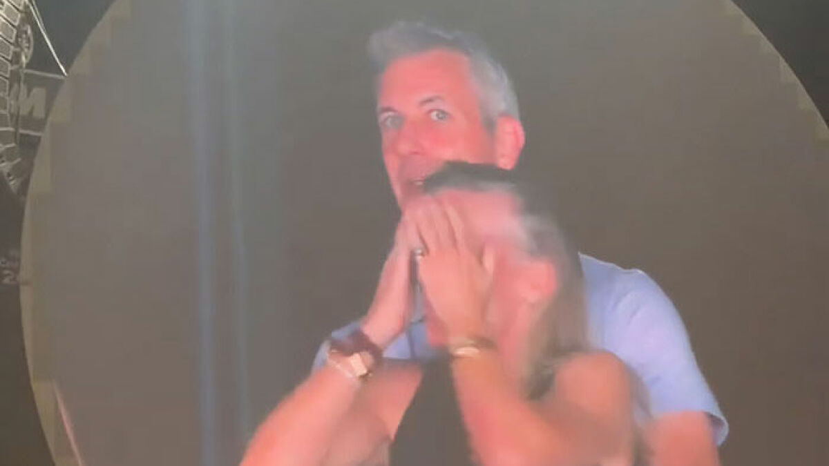 Man and woman reacting with surprise on stage during Coldplay kiss cam moment involving toxic CEO revealed by ex-employee.