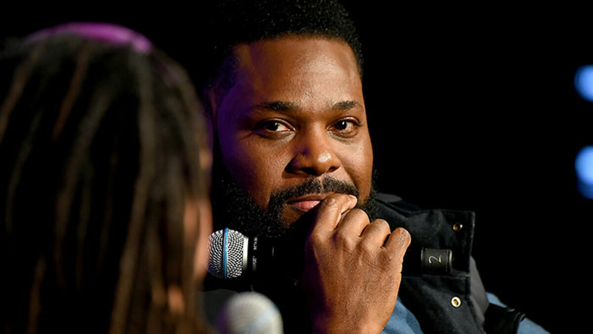 Man speaking into a microphone during an event, highlighting a second victim revealed in a tragic accident news story.
