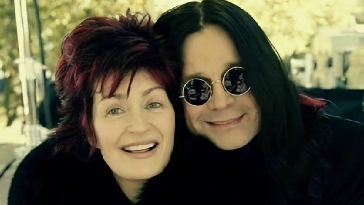 Sharon Osbourne and Ozzy Osbourne smiling together outdoors, capturing a heartfelt moment before his passing.
