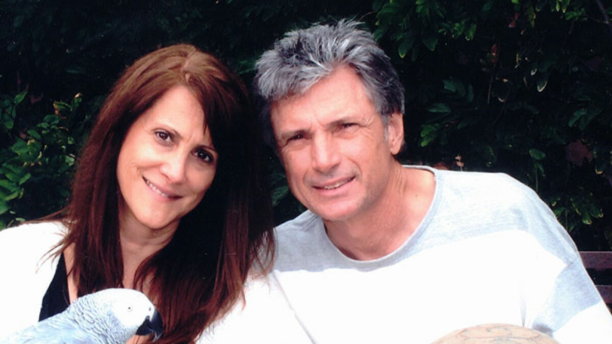 American Idol exec and husband pictured outdoors with a parrot, linked to epic police fail in a tragic 911 call case.