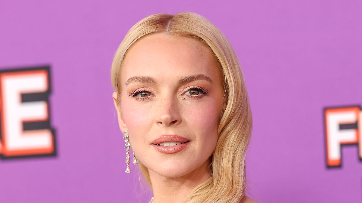 Lindsay Lohan with fresh-faced glow posing at an event amid plastic surgery drama and 10 years younger look