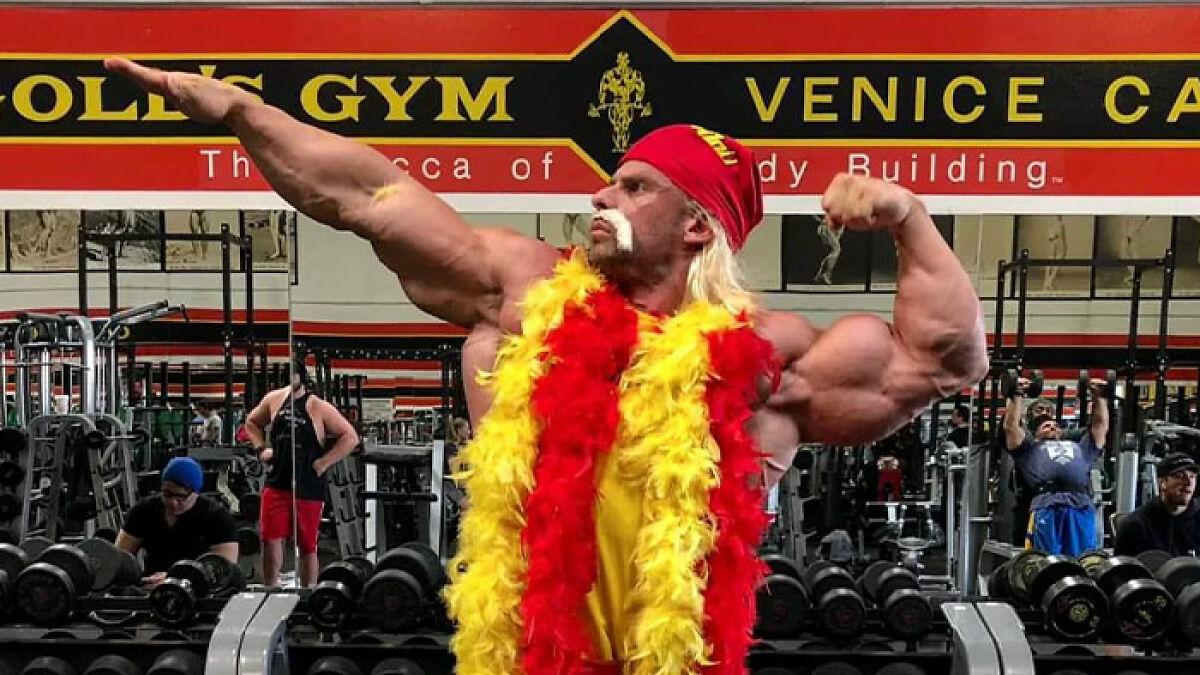 Bodybuilder Joey Swoll in colorful attire flexing muscles inside Gold's Gym Venice, linked to Hulk Hogan memorial controversy.