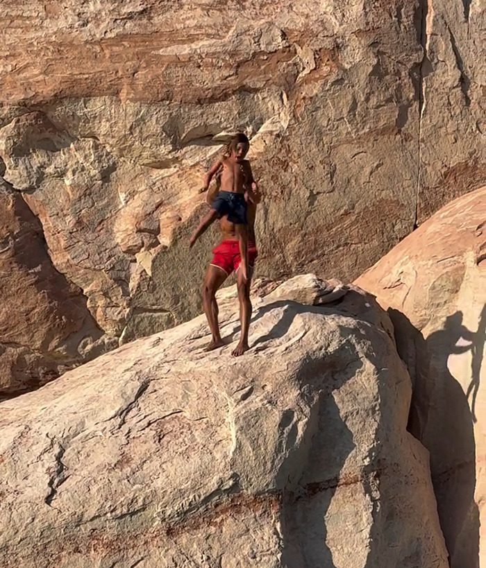 Dad throwing 7-year-old son off cliff to teach him to face his fears, captured on rocky terrain during daylight. Dad throwing 7-year-old son off cliff to teach him to face his fears, captured on rocky terrain during daylight.