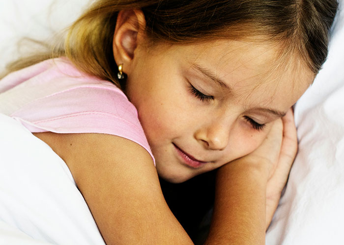 8-year-old girl sleeping peacefully at mom's boyfriend's house, illustrating child spending the night away from dad's presence. 8-year-old girl sleeping peacefully at mom's boyfriend's house, illustrating child spending the night away from dad's presence.