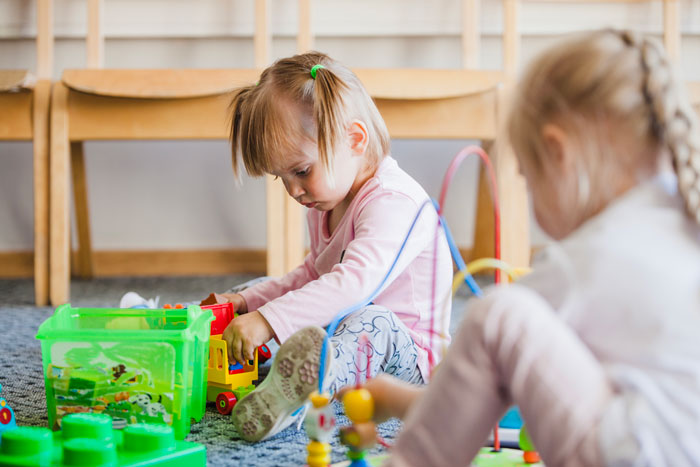 Two young children playing with toys at daycare, highlighting concerns about custody weeks and CPS involvement. Two young children playing with toys at daycare, highlighting concerns about custody weeks and CPS involvement.