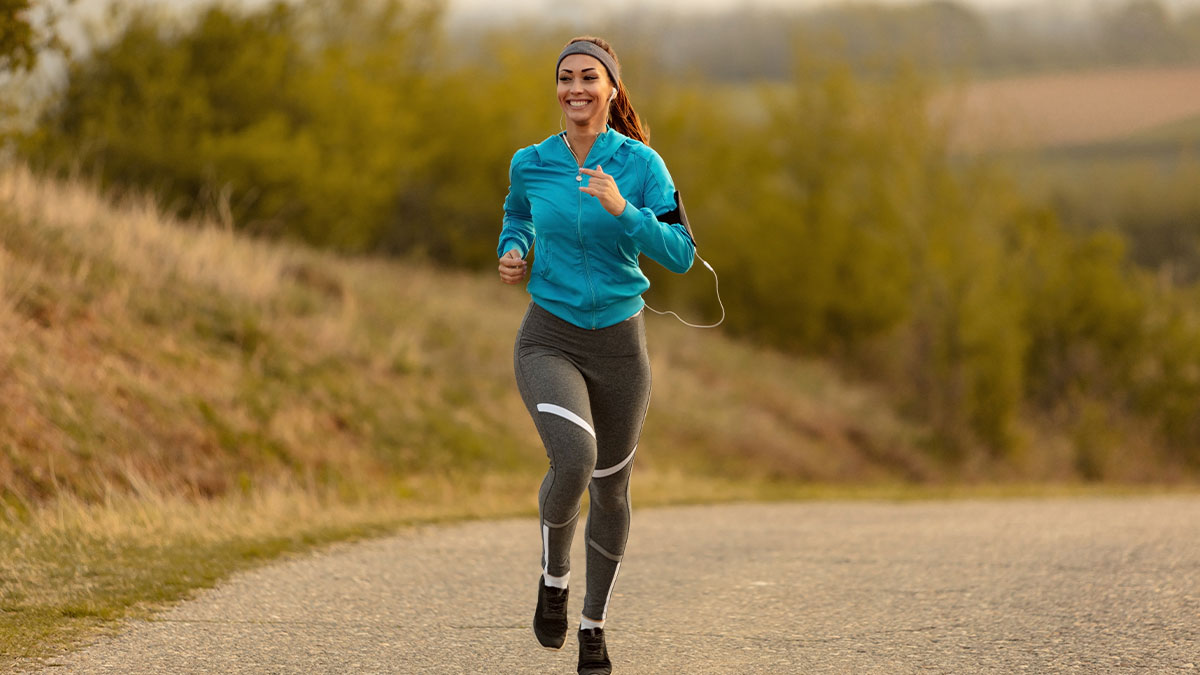 Woman jogging outdoors wearing headphones and athletic wear, illustrating deaf people reveal surprisingly silent things.