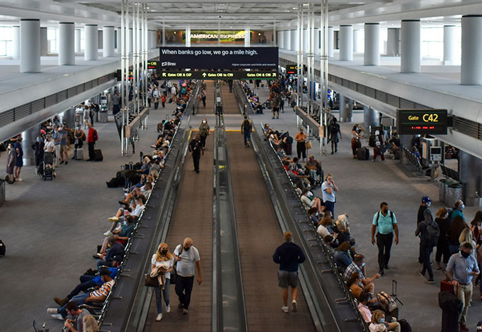 Busy airport terminal with travelers and United Airlines crew amid trafficking accusations involving foster dad and Latina daughters. Busy airport terminal with travelers and United Airlines crew amid trafficking accusations involving foster dad and Latina daughters.