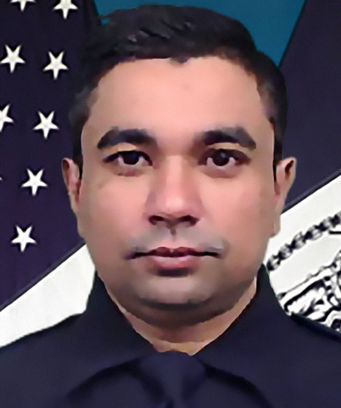 NYPD cop in uniform with American flag background, honored for protecting others and fatally shot in line of duty. NYPD cop in uniform with American flag background, honored for protecting others and fatally shot in line of duty.