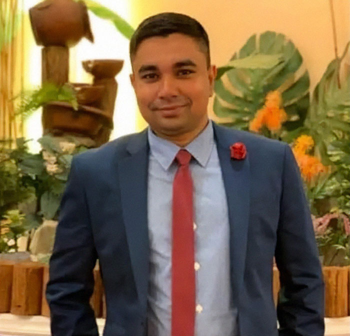 NYPD cop in a suit with a red tie, smiling in a decorated indoor setting, honored for protecting others. NYPD cop in a suit with a red tie, smiling in a decorated indoor setting, honored for protecting others.