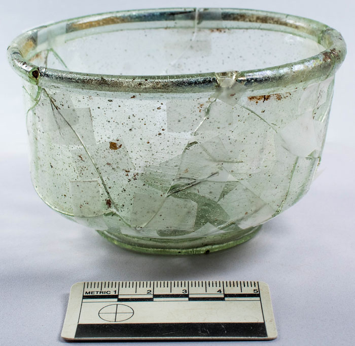 Ancient glass bowl reconstructed from fragments uncovered during Roman Empire and Iron Age highway construction findings. Ancient glass bowl reconstructed from fragments uncovered during Roman Empire and Iron Age highway construction findings.