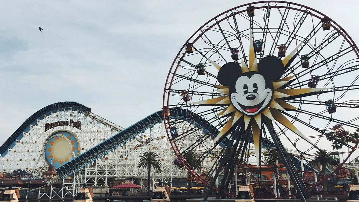 Mickey Mouse ferris wheel and roller coaster at Disneylandu2019s Paradise Pier, a once adored but now outdated attraction.