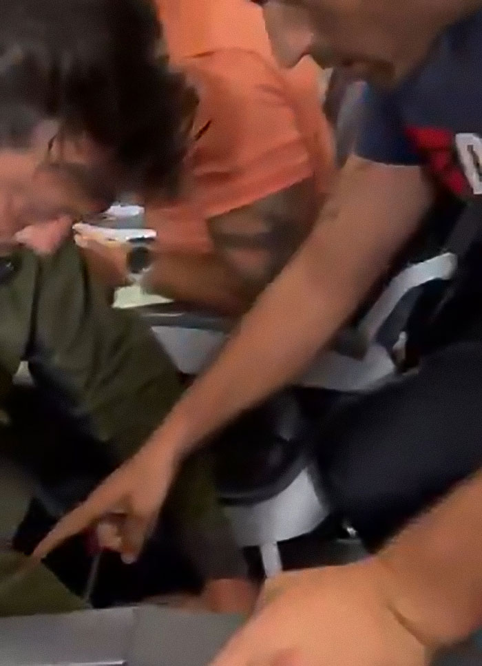 Passengers tackling man who threatens to explode plane mid-flight in dramatic altercation inside airplane cabin. Passengers tackling man who threatens to explode plane mid-flight in dramatic altercation inside airplane cabin.