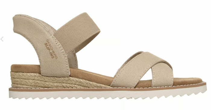 Beige comfortable sandal with fabric straps and a woven sole, perfect for stylish sandal season in Europe.