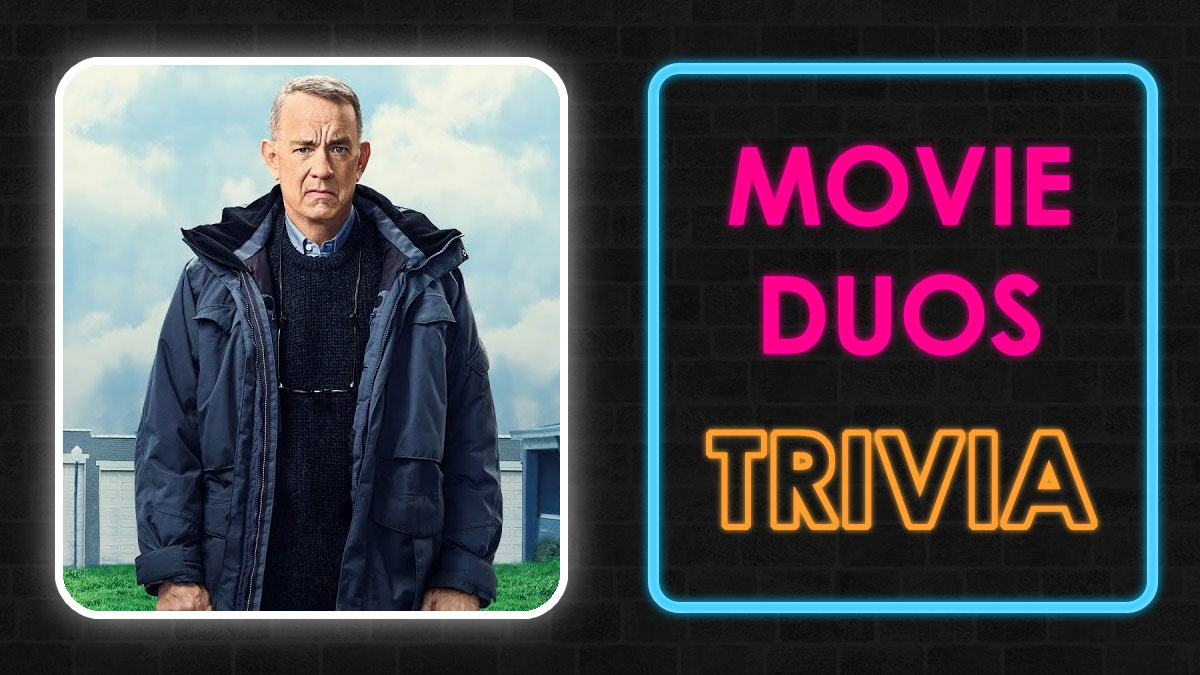 Man in dark jacket standing outside with a suburban background next to neon sign reading movie duos trivia quiz.