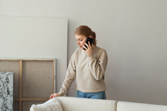Woman on phone in casual clothes at home amid vacation rift choosing friend over sister and niblings for the trip Woman on phone in casual clothes at home amid vacation rift choosing friend over sister and niblings for the trip