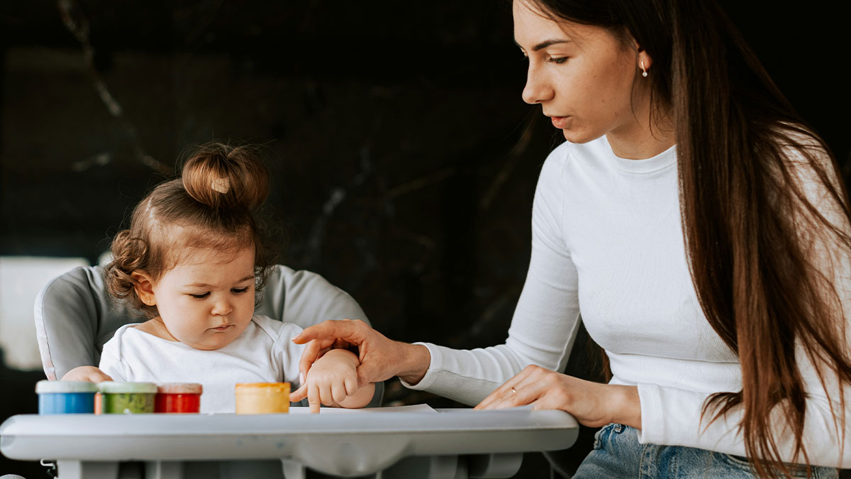 Person upset as friend refuses to pay more for babysitting after winning the lottery, showing frustration during childcare.