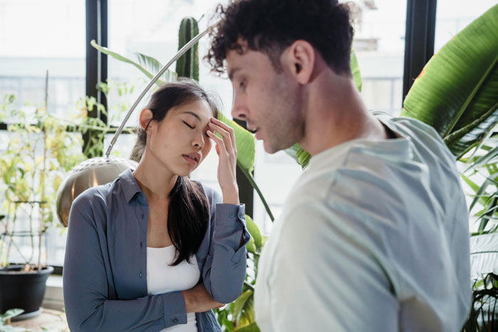 Young man expecting girlfriend to get his mom a Mother's Day gift, while she feels shocked and stressed during conversation. Young man expecting girlfriend to get his mom a Mother's Day gift, while she feels shocked and stressed during conversation.