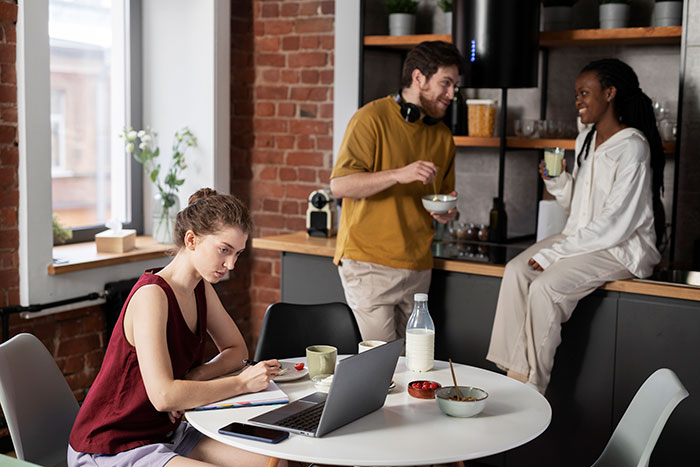 Young man confused why girlfriend stopped visiting mornings, causing tension with his mom in a modern kitchen setting. Young man confused why girlfriend stopped visiting mornings, causing tension with his mom in a modern kitchen setting.