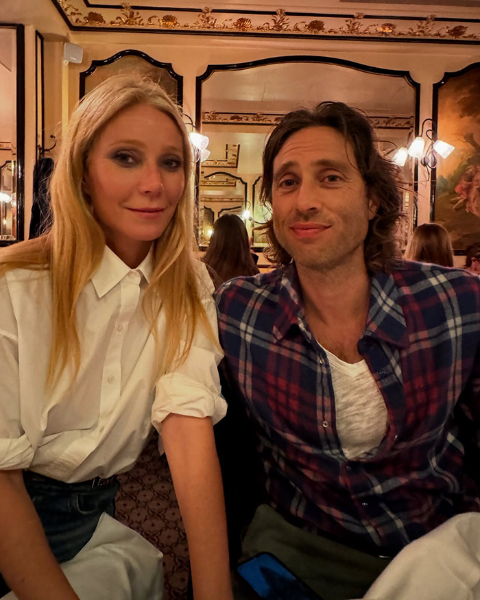 Gwyneth Paltrow and a man sitting in a cozy restaurant setting, related to trash-handling skills in cooking video. Gwyneth Paltrow and a man sitting in a cozy restaurant setting, related to trash-handling skills in cooking video.