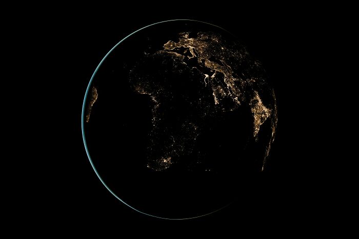 Earth at night showing illuminated cities, illustrating bizarre beliefs about the world despite science myth busting.