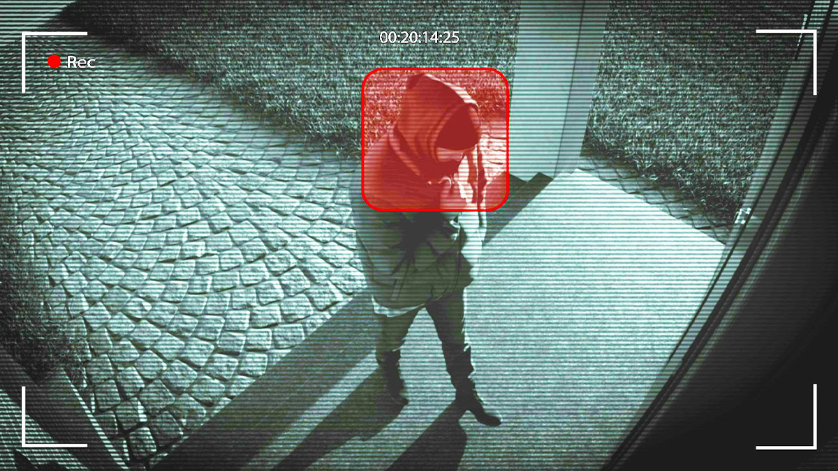 Person in hoodie caught on security camera at night, related to messed up school incidents and security concerns.