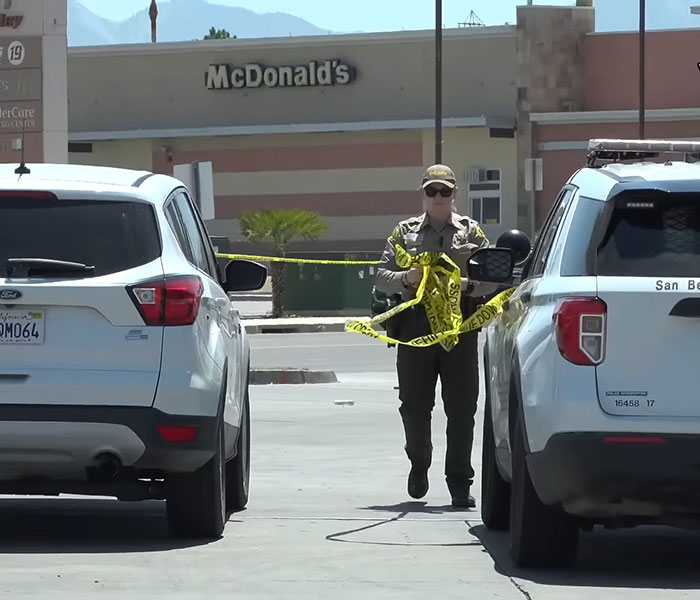 Police officer setting up crime scene tape outside convenience store near vehicles after horrifying teddy bear covered in apparent human remains found Police officer setting up crime scene tape outside convenience store near vehicles after horrifying teddy bear covered in apparent human remains found