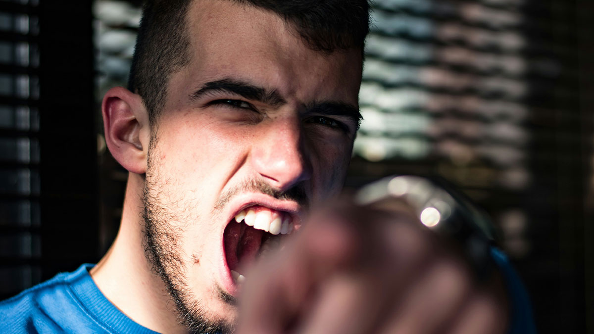 Angry man shouting and pointing, symbolizing accusations in a lady accused of cheating due to daughter's dark skin.