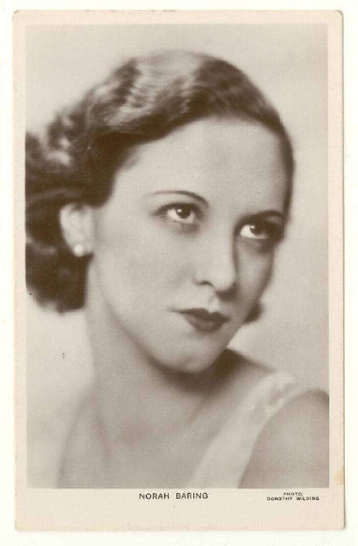 Vintage postcard featuring a portrait of a 1930s woman with styled hair and classic makeup, capturing 1930s charm.