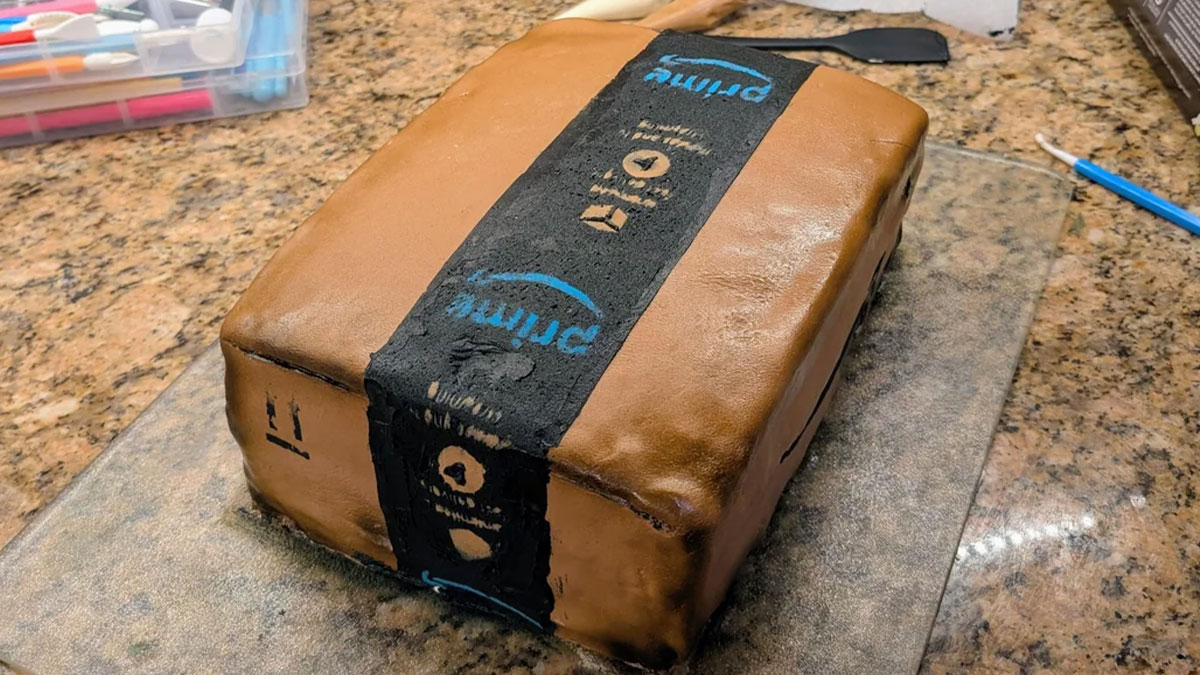 Realistic baked goods cake designed to look like an Amazon Prime package on a kitchen countertop