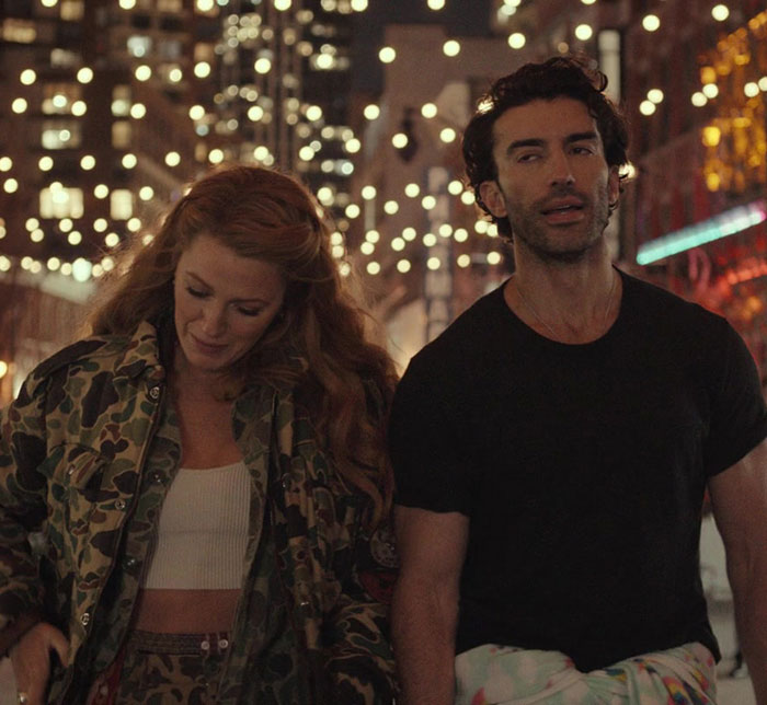 Blake Lively walking with a man at night under city lights, showcasing a casual and candid moment. Blake Lively walking with a man at night under city lights, showcasing a casual and candid moment.