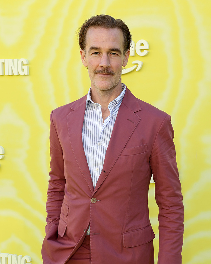 James Van Der Beek in a maroon suit, posing against a yellow backdrop during his cancer journey with difficult moments with kids. James Van Der Beek in a maroon suit, posing against a yellow backdrop during his cancer journey with difficult moments with kids.