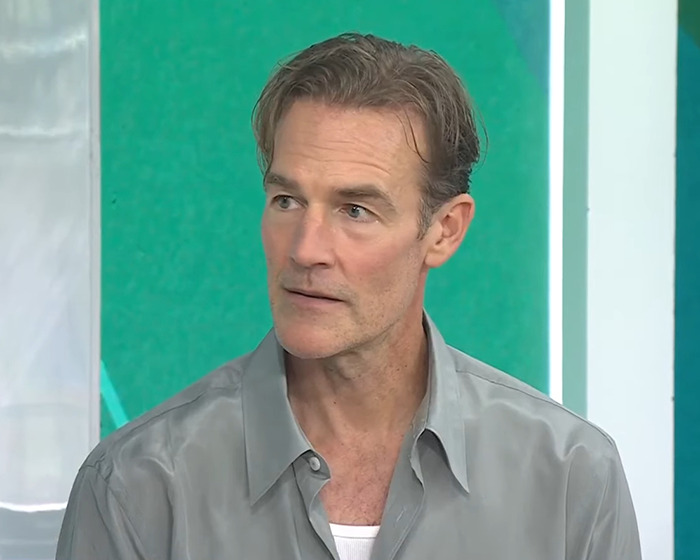 James Van Der Beek in a gray shirt sharing about a difficult moment with kids during his cancer journey in an interview setting James Van Der Beek in a gray shirt sharing about a difficult moment with kids during his cancer journey in an interview setting