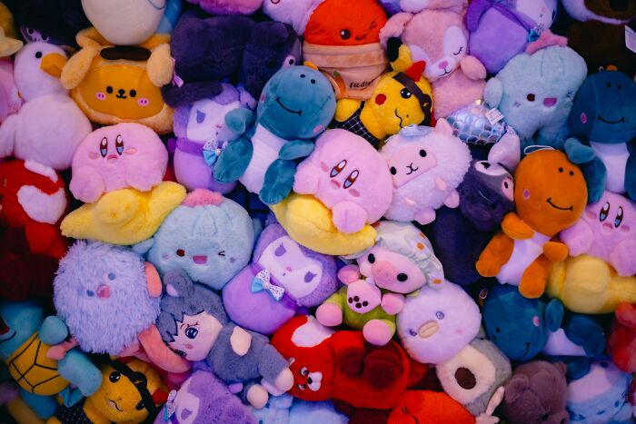 Pile of colorful plush toys representing trends leading to overconsumption and growing concerns about excess buying.