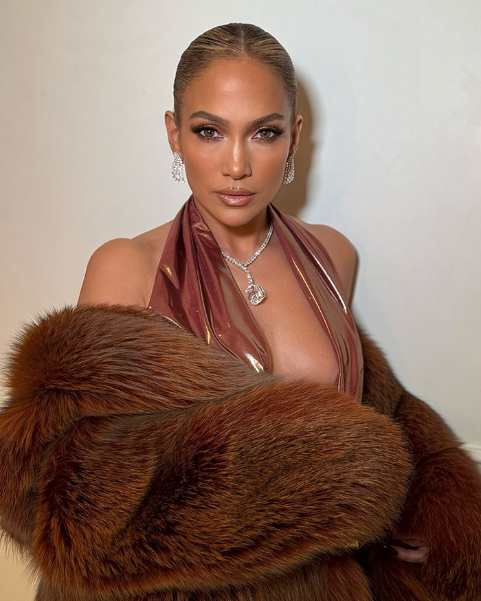 Jennifer Lopez wearing glamorous fur coat and jewelry, facing camera with confident expression in stylish look. Jennifer Lopez wearing glamorous fur coat and jewelry, facing camera with confident expression in stylish look.
