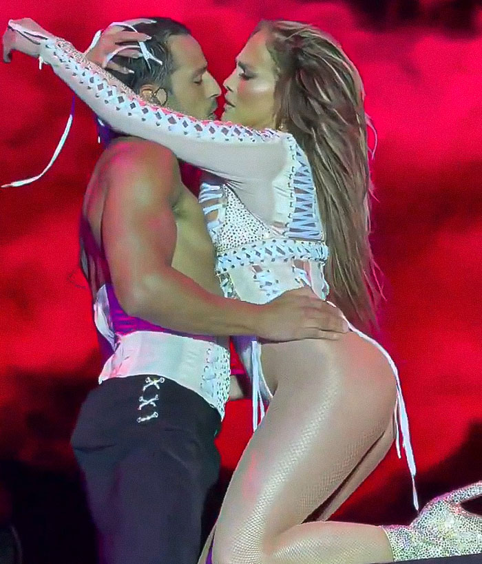Jennifer Lopez performing raunchy dance moves with a partner on stage during a controversial show. Jennifer Lopez performing raunchy dance moves with a partner on stage during a controversial show.